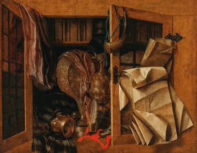 A trompe-l’oeil still life of a cupboard with books, gilded vessels, a hunting horn and drawings by Franciscus Gijsbrechts…