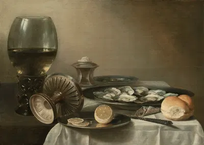 A large roemer, overturned tazza, salt cellar, partially sliced lemon, oysters, pepper, knife and bread on a partially…