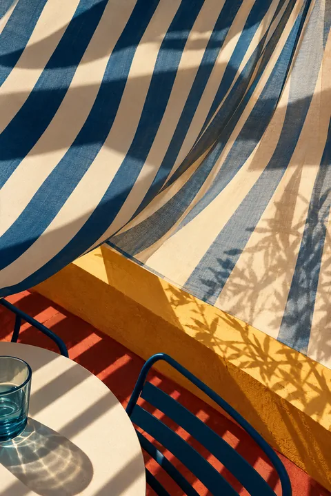 Striped Umbrella on a Sunlit Terrace