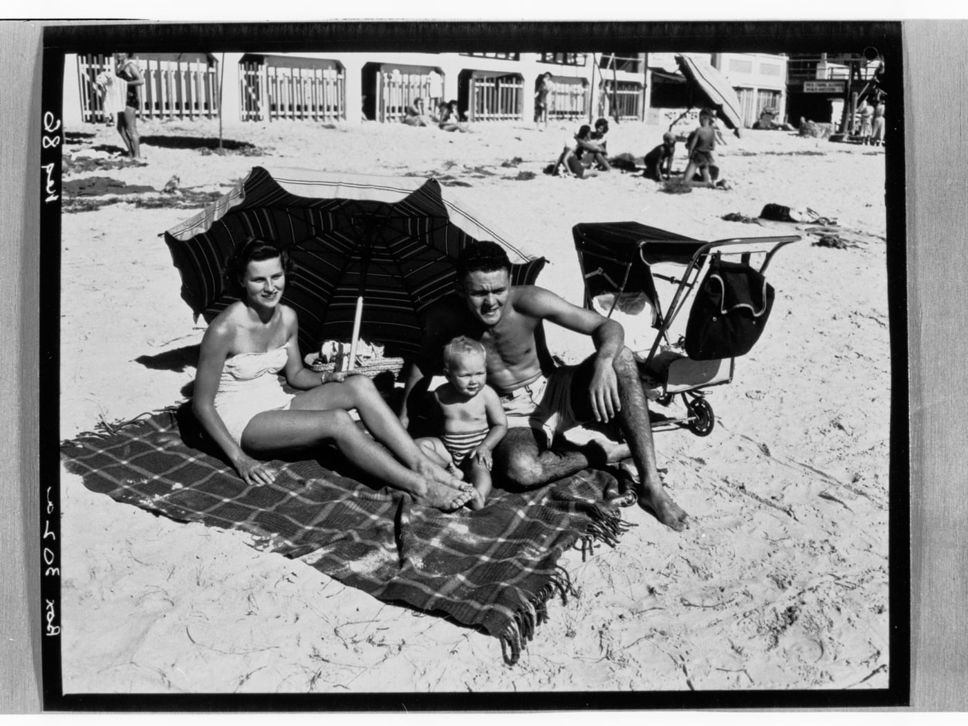 Henley Beach — Family Under Umbrella by State Government Photographer, c. 1955 — digital art print download