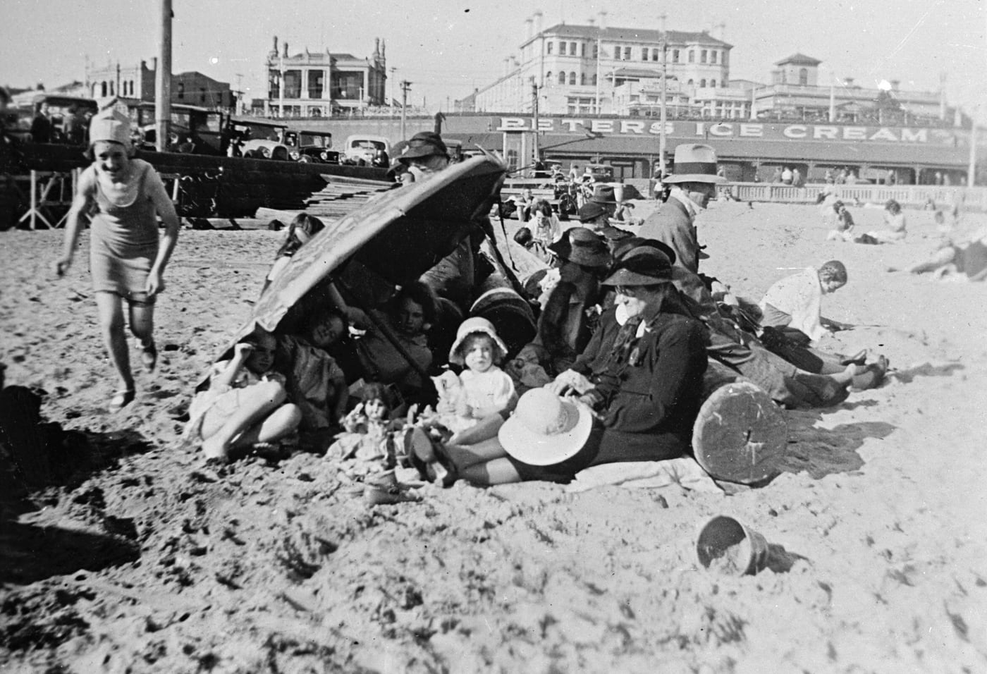 St Kilda Beach — Family Under Umbrella by Unidentified photographer, 1933 — digital art print download